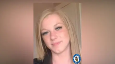 West Midlands Police A woman's selfie. She has straight blonde hair to her shoulders and is smiling. She is wearing black false eye lashes.