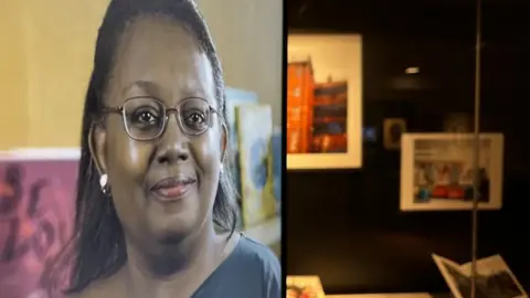 Andrew Turner/BBC Malorie Blackman on a video screen with artworks used to illustrate her books on display at the Time and Tide Museum in Great Yarmouth