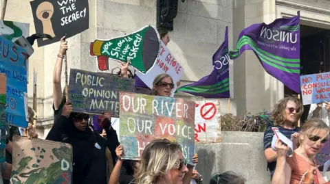 LDRS Protesters outside Southampton City Council hold hand-painted placards, which say "Our River, Our Voice", "Public Opinion Matters" and "You Should Have Asked!"