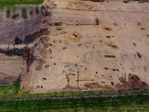 Archaeological Research Services A drone shot of an excavation which includes a Late Iron Age to Early Roman roundhouse in the centre