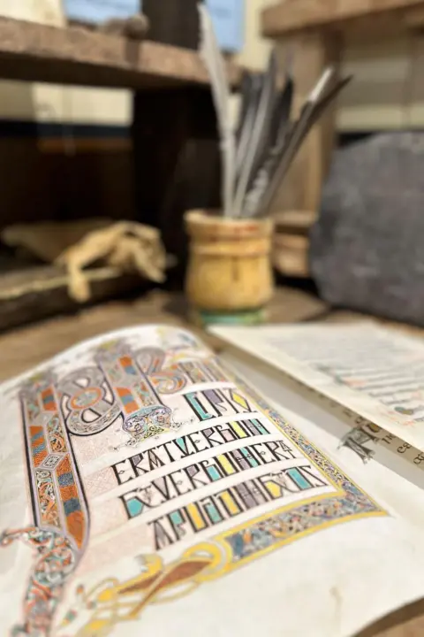 Samir Atmane Gospel incipit folio, feathers, scribe’s desk, slate sketch