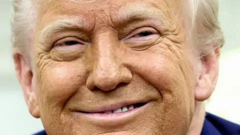 Reuters US President Donald Trump smiles in the Oval Office