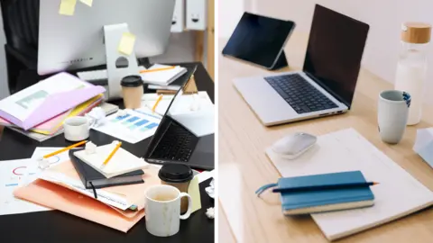 Getty Images Two desks shown side by side, with work items in the foreground. The left desk is cluttered with notebooks, loose papers, sticky notes, coffee cups, and an open laptop. The right desk is neatly arranged with a closed notebook, a laptop, tablet, mouse, water bottle, and a mug placed on a clear surface.