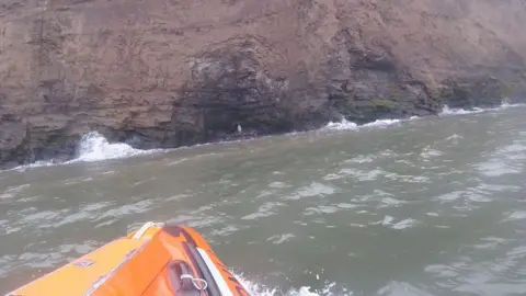 RNLI/Redcar The rescue showing the man and woman at the cave