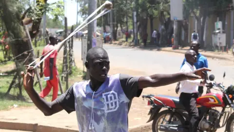 Reuters A man catapults a stone in Kisumu, Kenya - Monday 2 October 2017
