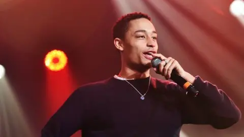 BBC/Alan Braidwood Picture of Loyle Carner performing