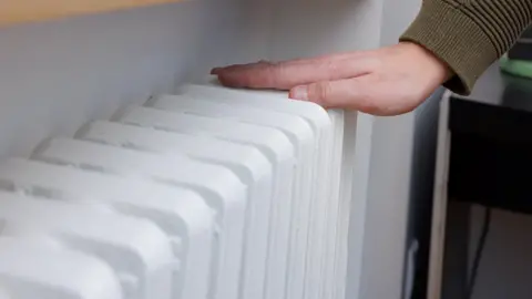 Getty Images Hand on heater