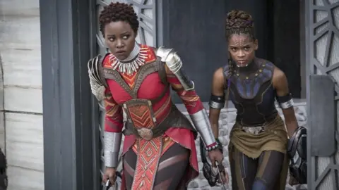 Marvel Studios Nakia (Lupita Nyong"o) and Shuri (Letitia Wright) in still from Black Panther