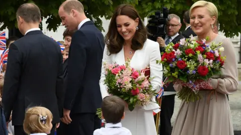 AFP/Getty Images The duchess and Poland's first lady received flowers after a meeting at the presidential palace