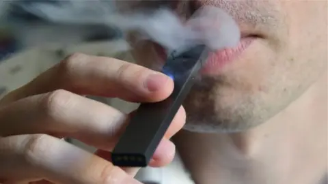 AFP Man smokes electronic cigarette