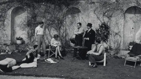 Christies Lord Berners entertaining Frederick Aston (far left) and Gertrude Stein (right) at Easter 1939