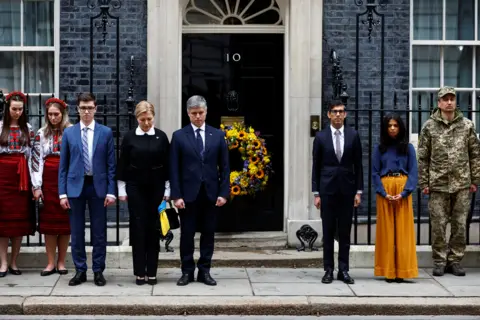 PETER NICHOLLS/reuters Britain's Prime Minister Rishi Sunak and his wife Akshata Murthy, Ukrainian Ambassador to UK Vadym Prystaiko and wife Inna Prystaiko observe a minute's silence to mark the one year anniversary of Russia's invasion of Ukraine, in London, Britain, February 24, 2023.