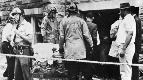 Alamy A victim is removed from the site of the Baptist Church Bombing