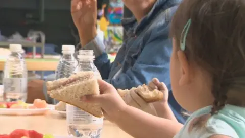 A child holding out a plate