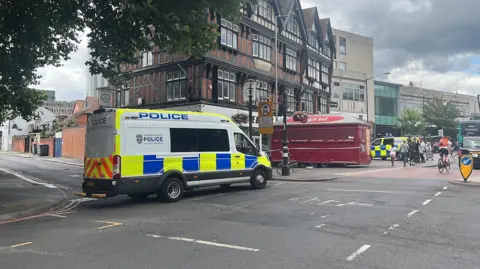 BBC A general view picture of a police van parked up in Hosier Street, Reading, which is partly cordoned off with police tape.