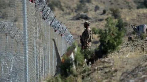 File photo of a soldier standing along the Pakistan-Afghanistan border