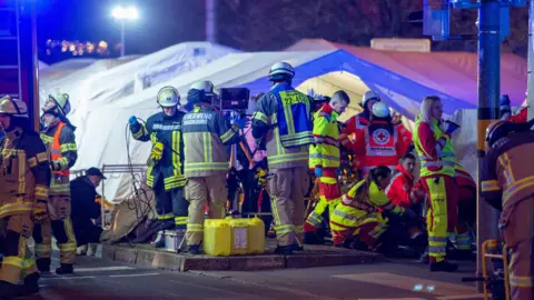 Getty ImagesFirefighters and emergency responders set up triage units near the Christmas market in Magdeburg