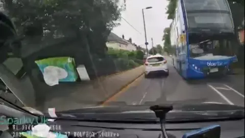 Bus appears coming towards middle of the road towards oncoming traffic