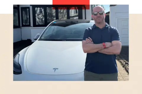 Ben Kilbey stands in front of his Tesla Model Y