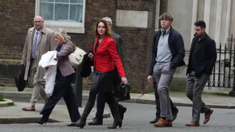 Jordan Pettitt/PA Wire A group of people in Downing Street wearing smart clothes