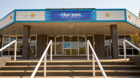 Horizon Leisure Centre, outside the building taken from the bottom of the steps shows big blue sign with the words Horizon