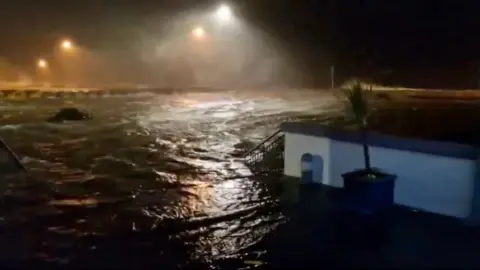 Flood waters surround Galway Atlantaquaria, in the dark of early morning