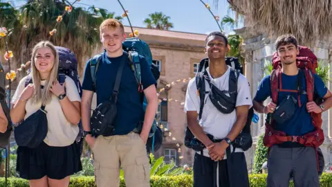 BBC/Studio Lambert Katie, Harrison, Jo and Kush smile as they stand with their backpacks in a Sicilian square at the start of the sixth series.