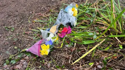 Bunches of flowers left in woodland