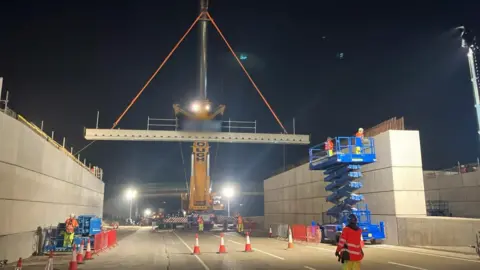National Highways A beam being lifted by a crane