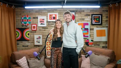 Harleymoon and Roman Kemp stand in the You About studio