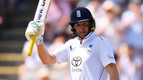 England batter Joe Root raises his bat after reaching fifty