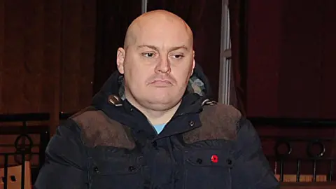 Pacemaker Ian Ogle, wearing black jacket with red Poppy badge