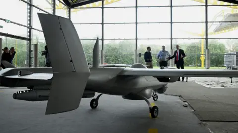 PA Media Giant factory with a huge unmanned plane/drone in front of big windows