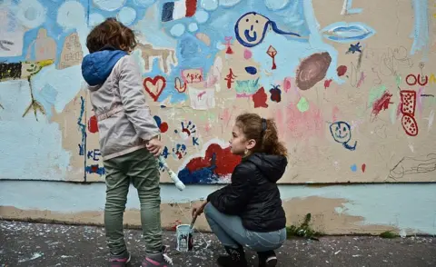 Getty Images A children painting on the wall near the Le Carillon in memorial of the victims of the terrorist attacks a month ago Paris, France on December 13, 2015