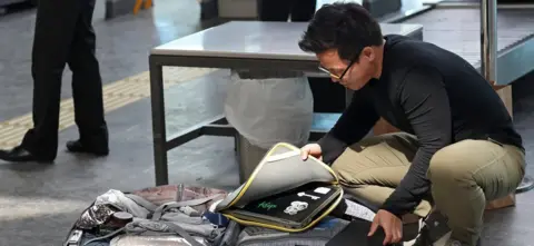 Getty Images Passenger packs laptop in Istanbul airport