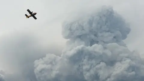 Reuters A firefighting plane passes smoke as it pulls up from the Zezere River after picking up water to put out forest fires in the area near Pedrógão Grande, June 18 2017.