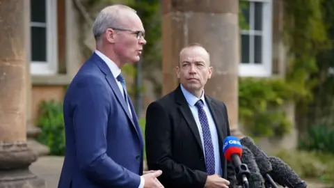 PA Media Coveney and Heaton-Harris at Hillsborough Castle