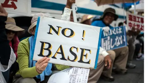 Getty Images Protests demanding the withdrawal of US bases are a common sight in Okinawa