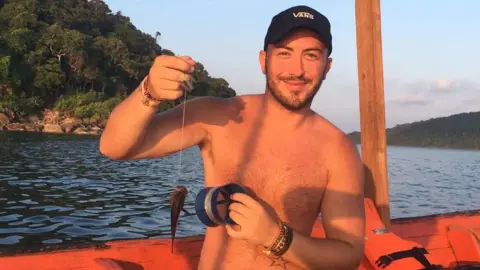 Family photo Calvin Hill pictured fishing in Cambodia