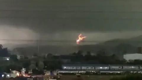 Fire erupts as tornado hits power lines