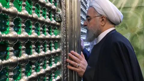 Reuters Iranian President Hassan Rouhani visits the shrine of Moussa al-Kadhim in Baghdad (11 March 2019)