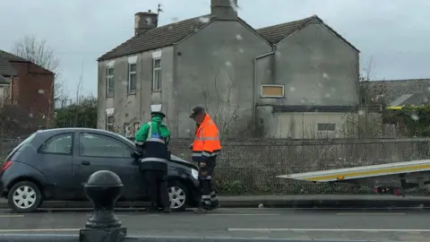 Mark Hennis Warden issuing parking ticket