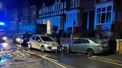 Warwickshire Police A vehicle crashed in a residential street