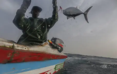 EPA Senegalese fisherman Modu Samba catches a fish in the Atlantic Ocean off the 400 year old fishing village of Ngor, near Dakar, 26 February 2019.