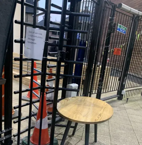 Ryan Gleeson Turnstile with chair and a road works cone blocking it