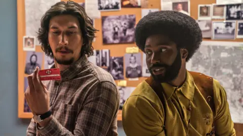 Universal Adam Driver and John David Washington