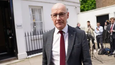 PA Media John Swinney speaks to the media outside the Resolution Foundation in Queen Anne's Gate, London, on Monday