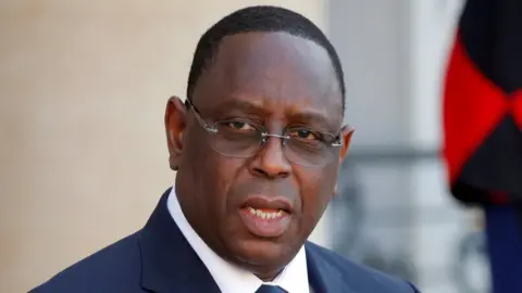 Reuters President Macky Sall leaving a conference
