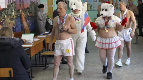 Reuters Members of the 'Polar Bear' winter swimming club vote in Barnaul, Russia, on 18 March 2018