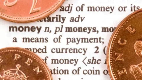 Getty Images Coins on dictionary